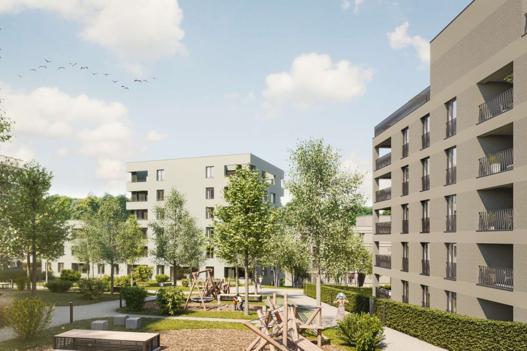 Ein moderner Wohnkomplex mit mehreren mittelhohen Gebäuden, grünen Bäumen, angelegten Gärten, Bänken und einem Spielplatz mit Schaukeln unter einem blauen Himmel mit vereinzelten Wolken und fliegenden Vögeln.